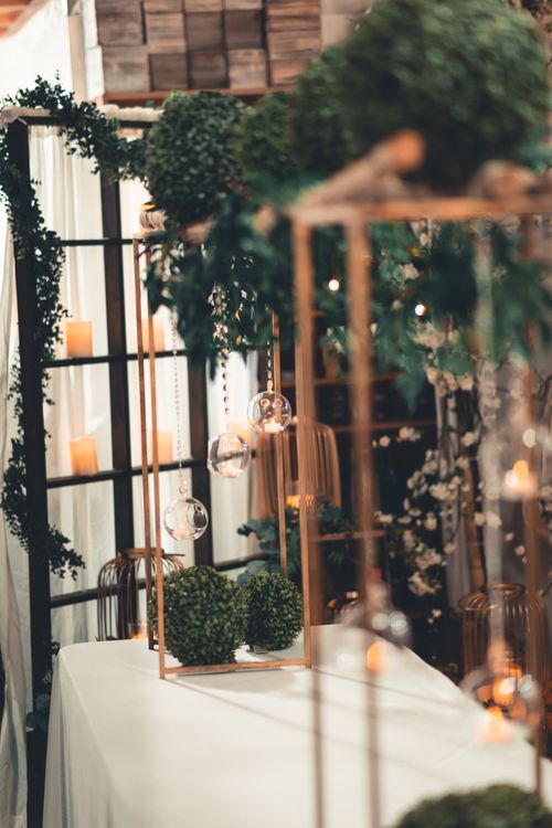 Free Close-up of indoor decor featuring candles and greenery on a table, creating a cozy ambiance. Stock Photo