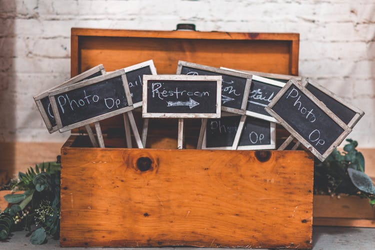 Black Signages On Wooden Chest Box