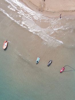 Stunning aerial view of boats on the shoreline of Kolympia Beach, Greece, capturing the essence of summer.