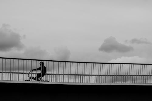 Man bikes on a bridge