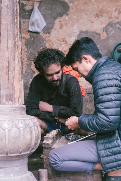 Free Two men skillfully collaborate in a rustic setting, focusing on craftsmanship and tools. Stock Photo