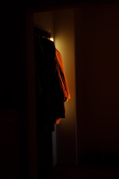 Orange Coat on a Hanger in Shadow 