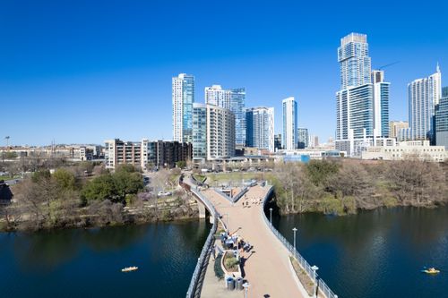 Free Stunning aerial view of Austin's modern skyline with a scenic riverfront bridge. Stock Photo