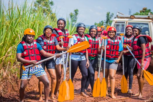 A group of people in life jackets and helmets on a river