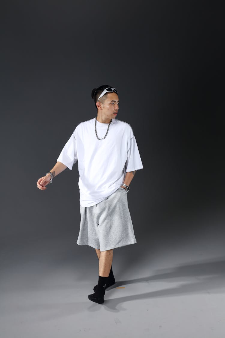 Man Wearing Oversized Clothes In A Studio 