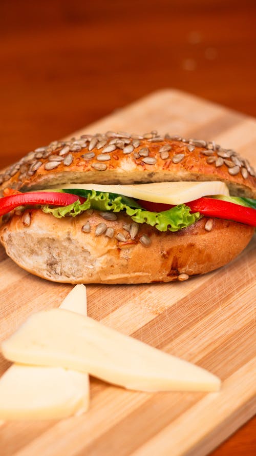 Sandwich with Vegetables and Cheese on a Cutting Board