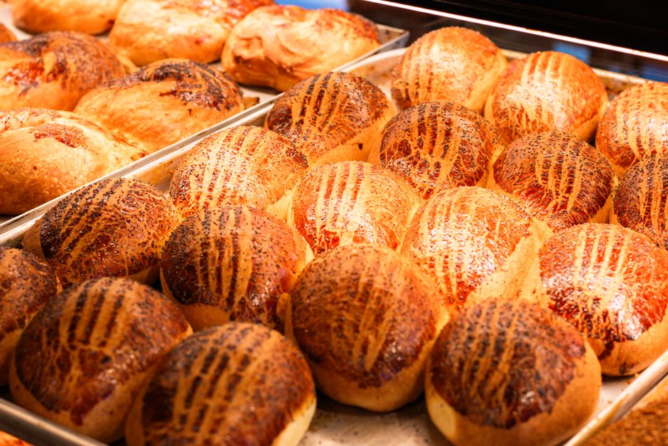 Delicious freshly baked poppy seed rolls in a bakery display, warm and inviting.