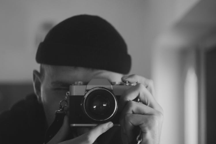 Closeup Of Photographer Looking Through Camera