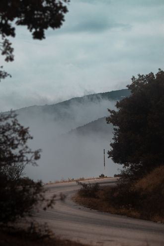 Winding road enveloped in mist by Orhan Pergel on Pexels