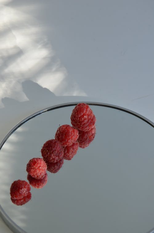 Raspberries Lying on a Mirror 