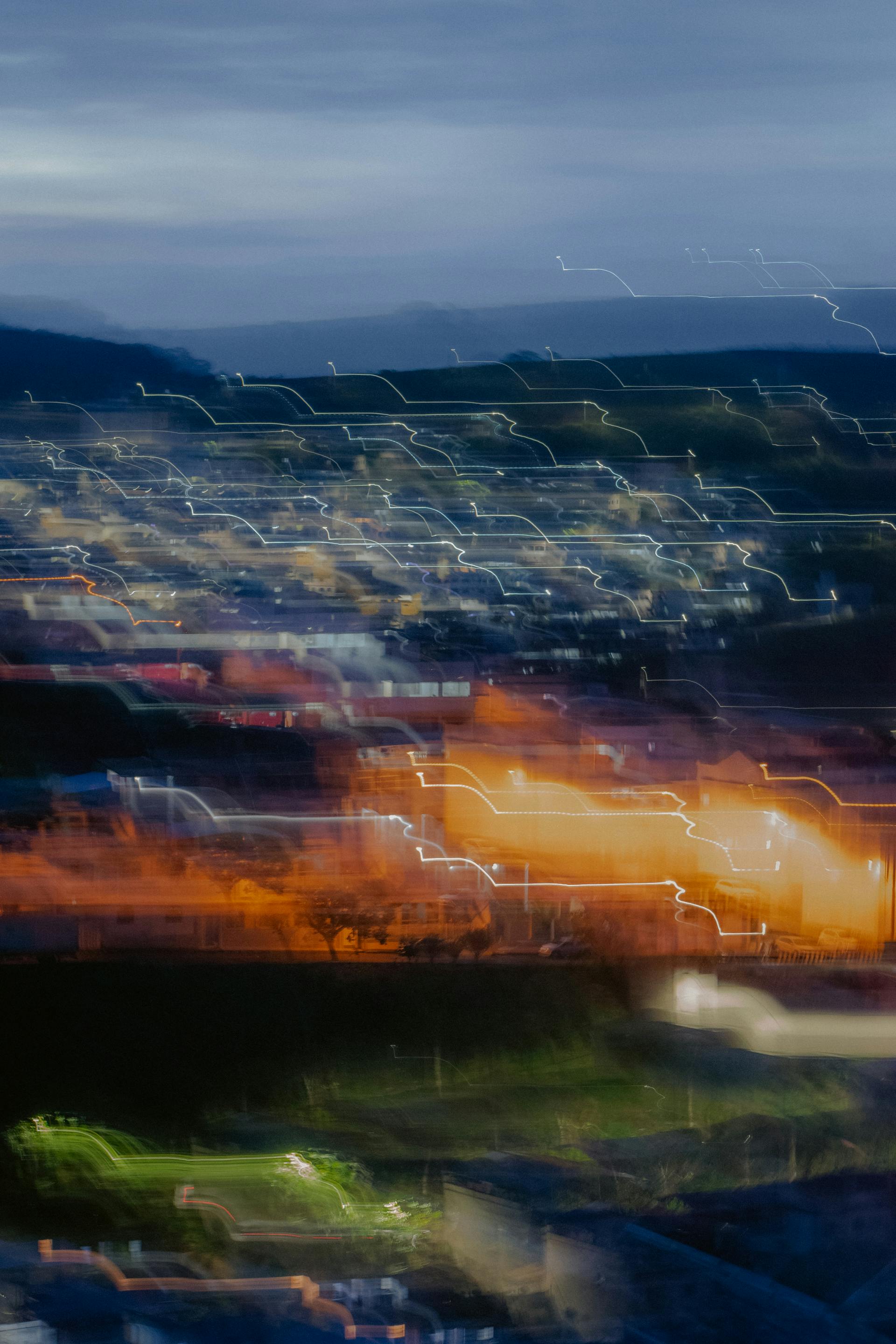 Abstract cityscape with motion blur, illuminating evening lights creating a vibrant urban scene.