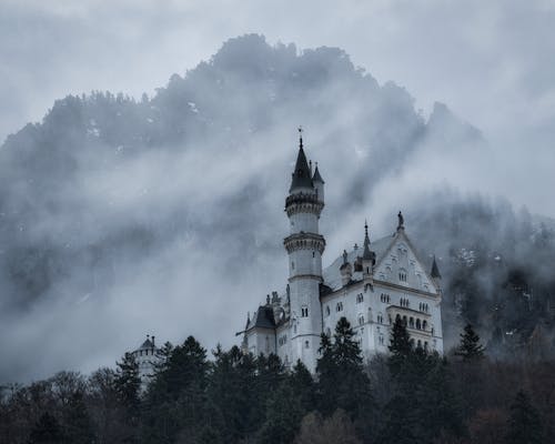 Neuschwanstein Castle on the Side of a Foggy Mountain