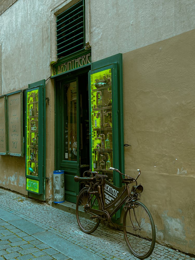 Advertising Bicycle In Front Of The Entrance To The Bar And Museum Absintherie In Prague