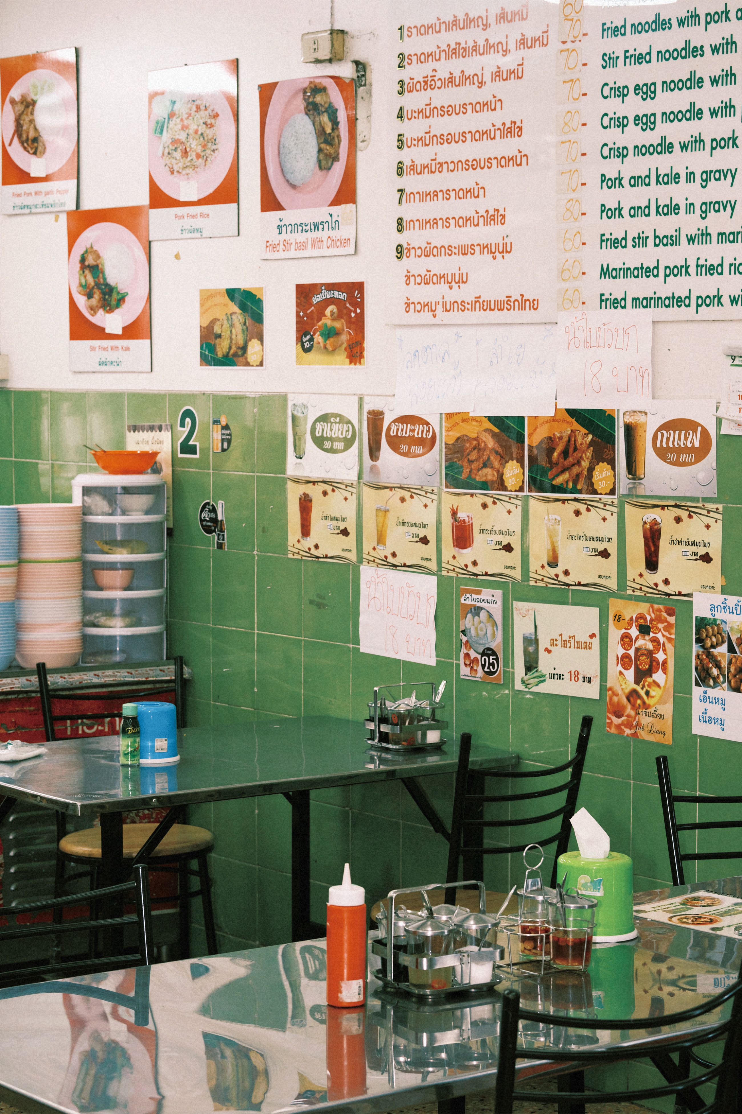 Charming interior of a local Thai restaurant with menu on display, inviting ambiance.