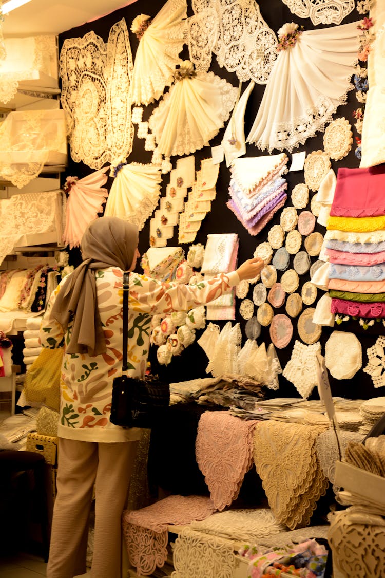 Woman Touching Lace Cloth At Store Retail Display