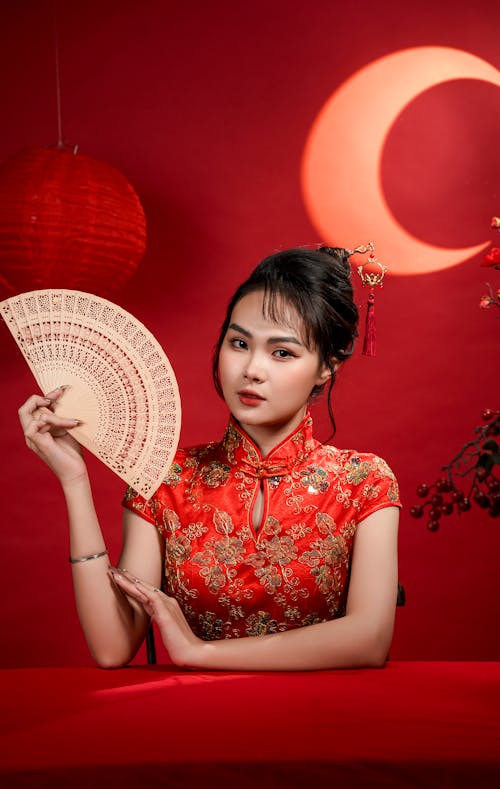 Woman in Traditional Clothing and with Fan