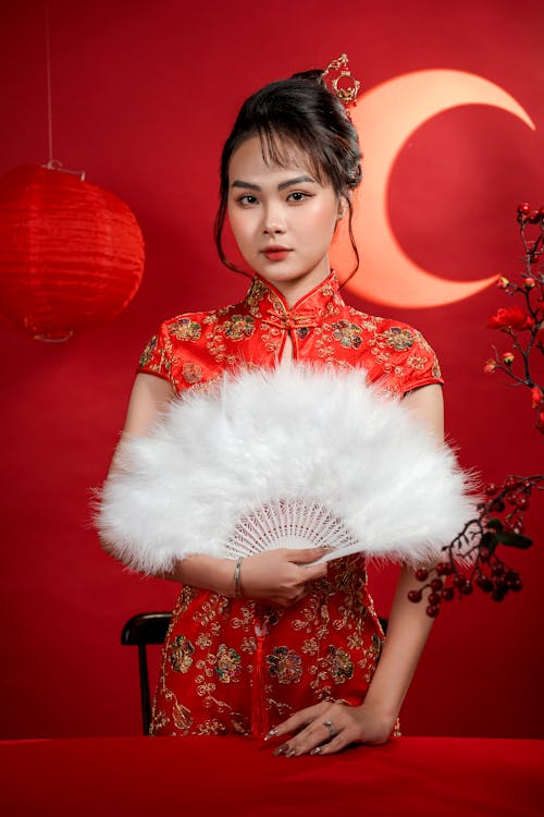 Model in Traditional Clothing Holding Fan