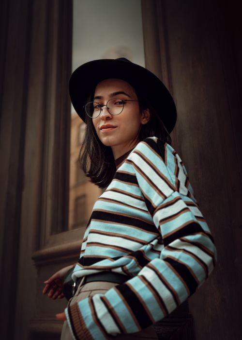 Free Portrait of a stylish woman wearing a hat and striped sweater in an urban setting in Istanbul. Stock Photo