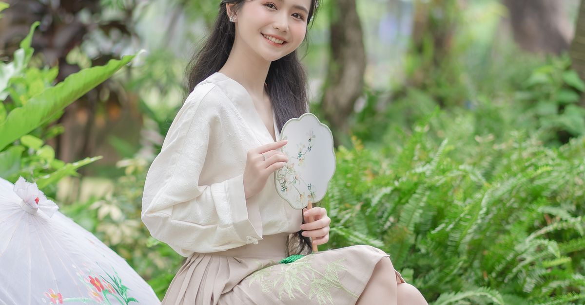 Woman in White Blouse and Beige Skirt Posing with Tuanshan Fan · Free ...