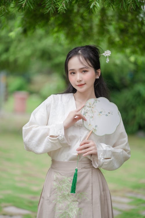 Brunette Woman in White Blouse Posing with a Tuanshan Fan