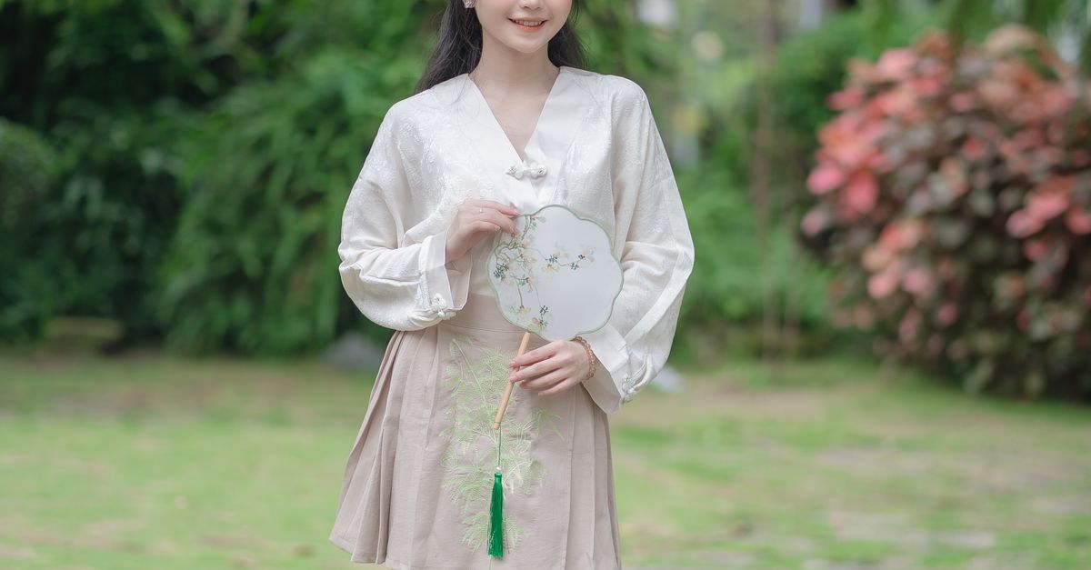Brunette Woman in White Blouse and Beige Mini Skirt Posing with ...