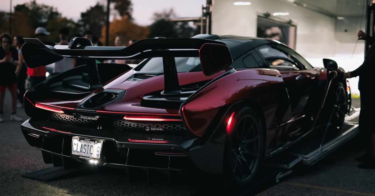 Stunning supercar with distinctive design at an outdoor car exhibition, showcasing automotive excellence.