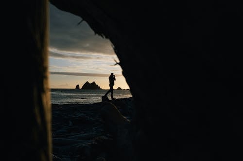 Silhouette of Man Walking on Beach