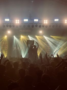 Vibrant concert atmosphere with a lively crowd and dynamic lighting effects.