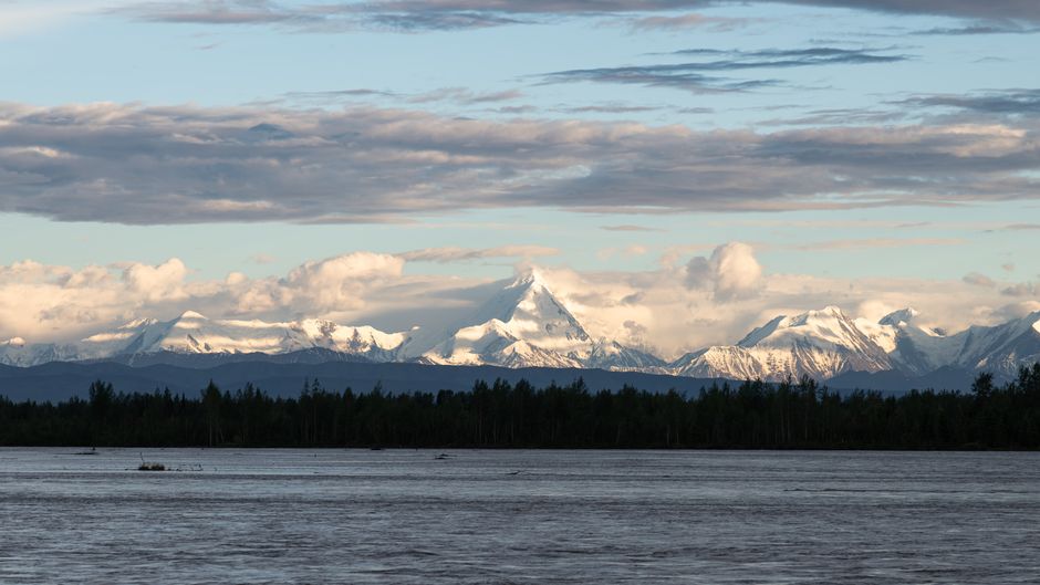 Incredible Wildlife Safari and Beach Campfire from Ketchikan Review: An Unforgettable Alaska Expedition Review 2026 - Majestic snow-capped mountains reflecting on a calm river at sunset, showcasing serene natural beauty.