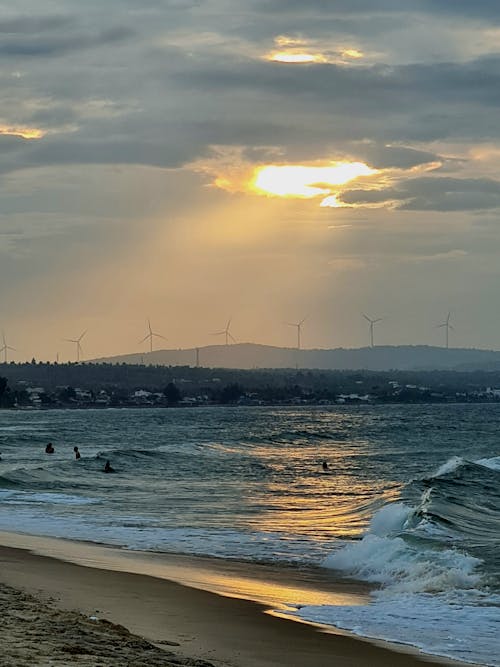 Foto profissional grátis de beira-mar, borrifando, cair da noite