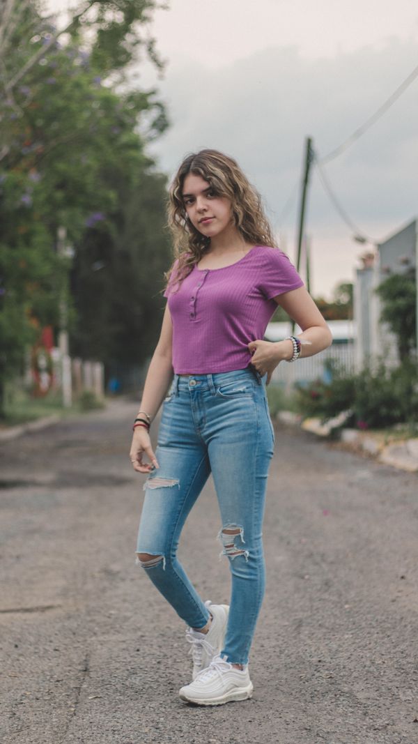 Woman wearing light-wash ripped skinny jeans
