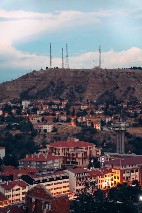 A city with a hill and a tower in the background