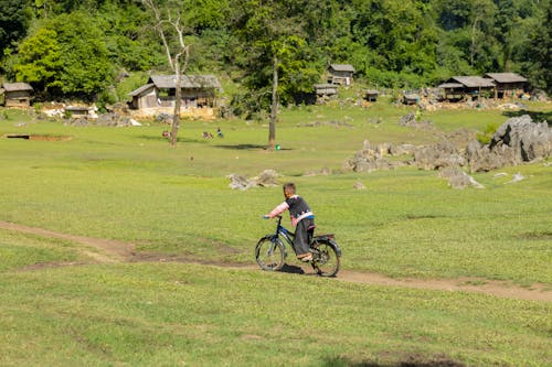 Boy on Bicycle in Countryside