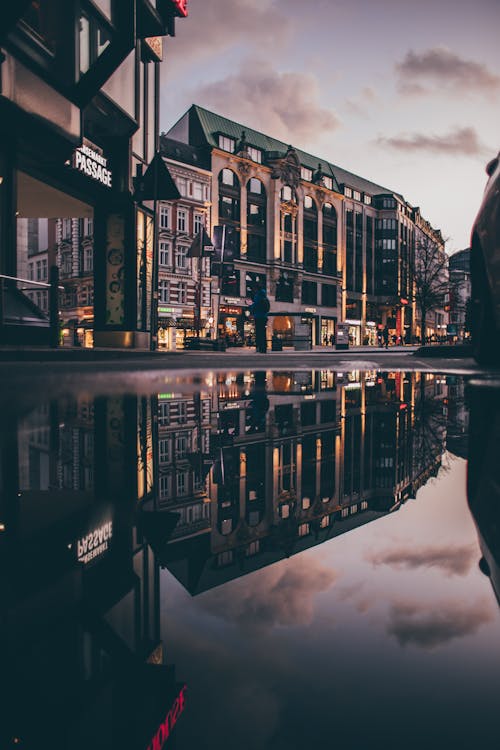 Old City Buildings Reflection in Puddles on Street