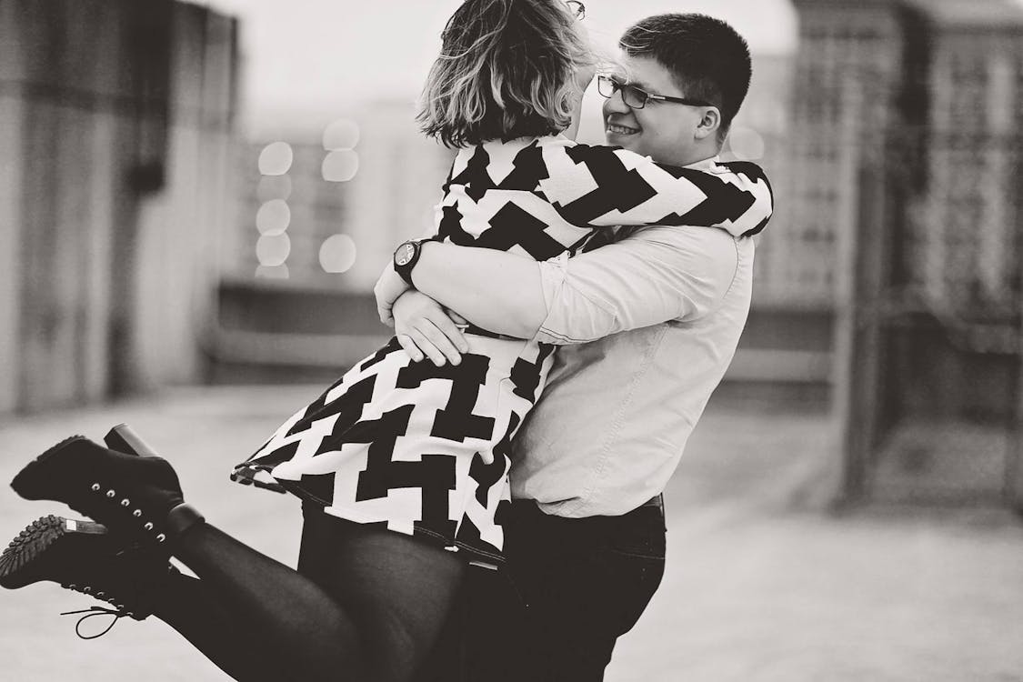 Rear View of Couple Walking in City