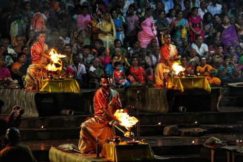 Free A vibrant scene of a Ganga Aarti ceremony at night with priests performing rituals before a crowd. Stock Photo