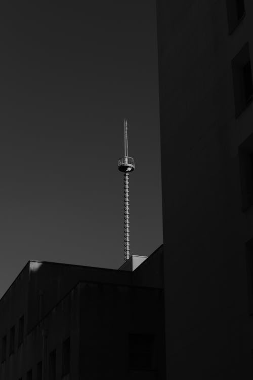 Black and White Photo of Buildings and a Tower in City 