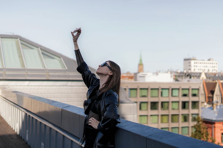 Young Woman Taking A Selfie On A Rooftop 