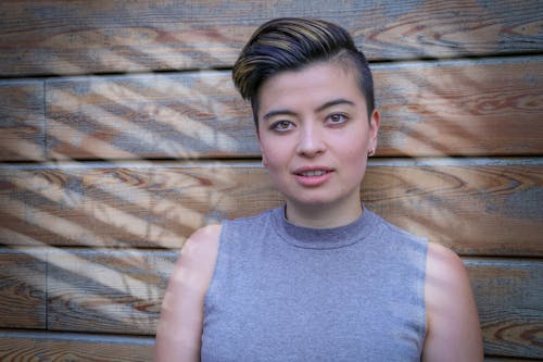 A woman with short hair and a grey top