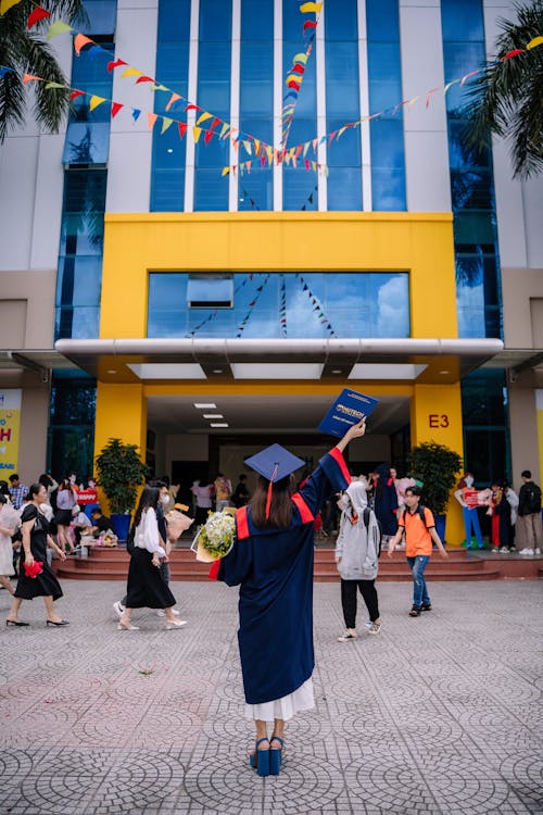 Woman in front of an University on a Graduation