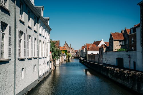 View of a Canal between Buildings in the Old Town of Bruges, Belgium 