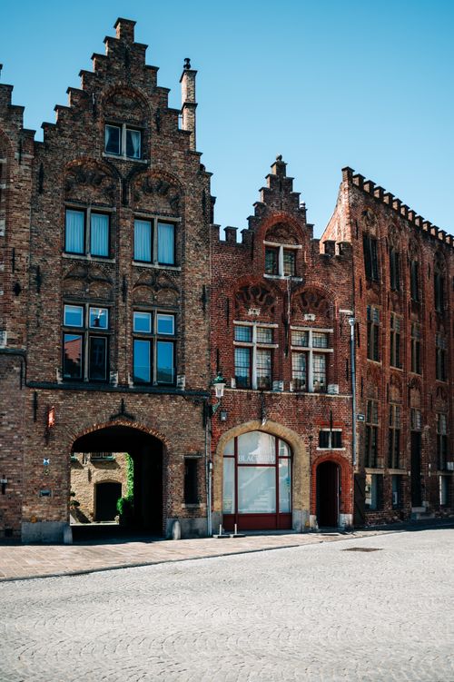 Free Explore the stunning facade of historic Flemish buildings in Bruges under a clear blue sky. Stock Photo