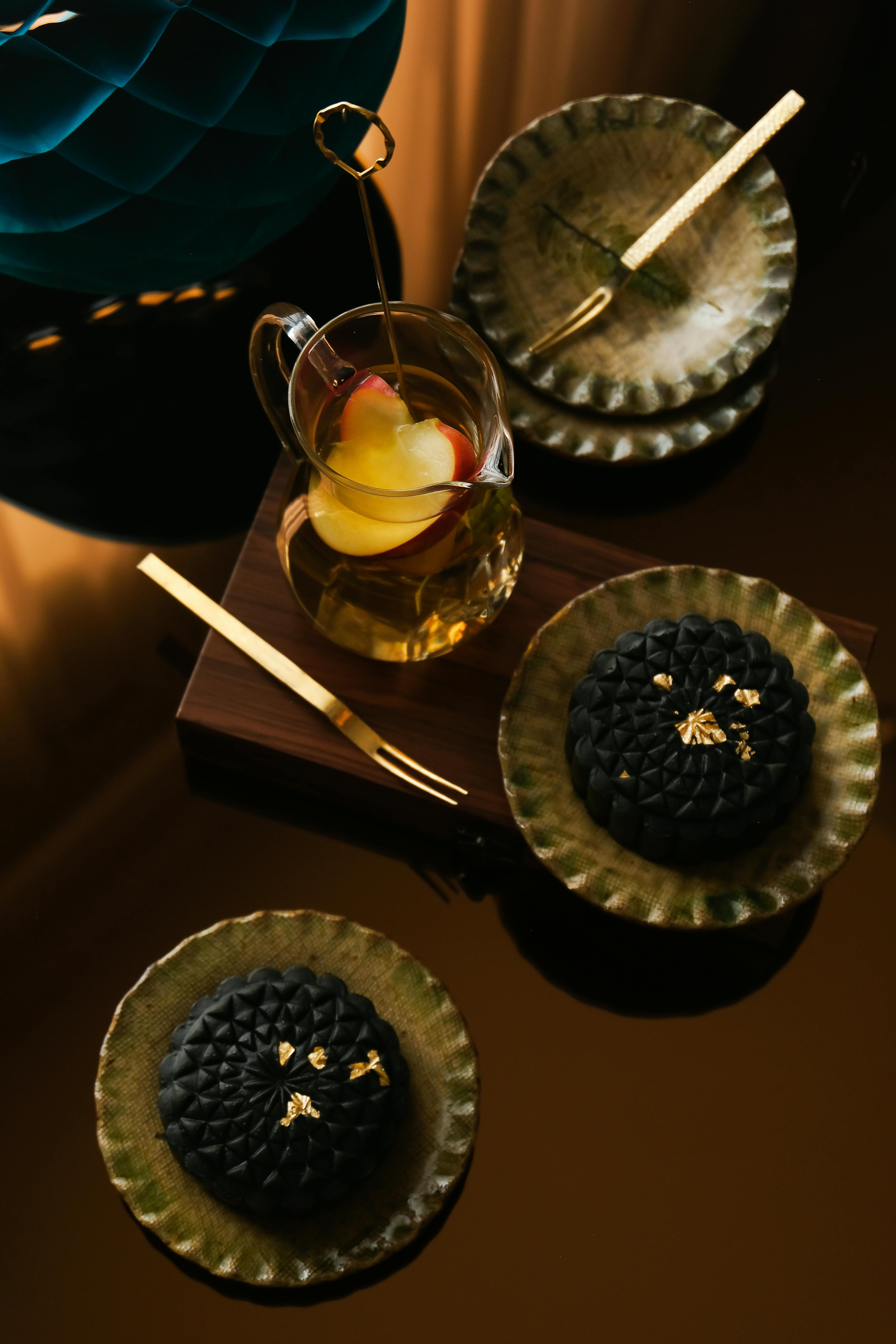 Elegant top view of black cakes with tea in a glass, set on a reflective surface in Ho Chi Minh.