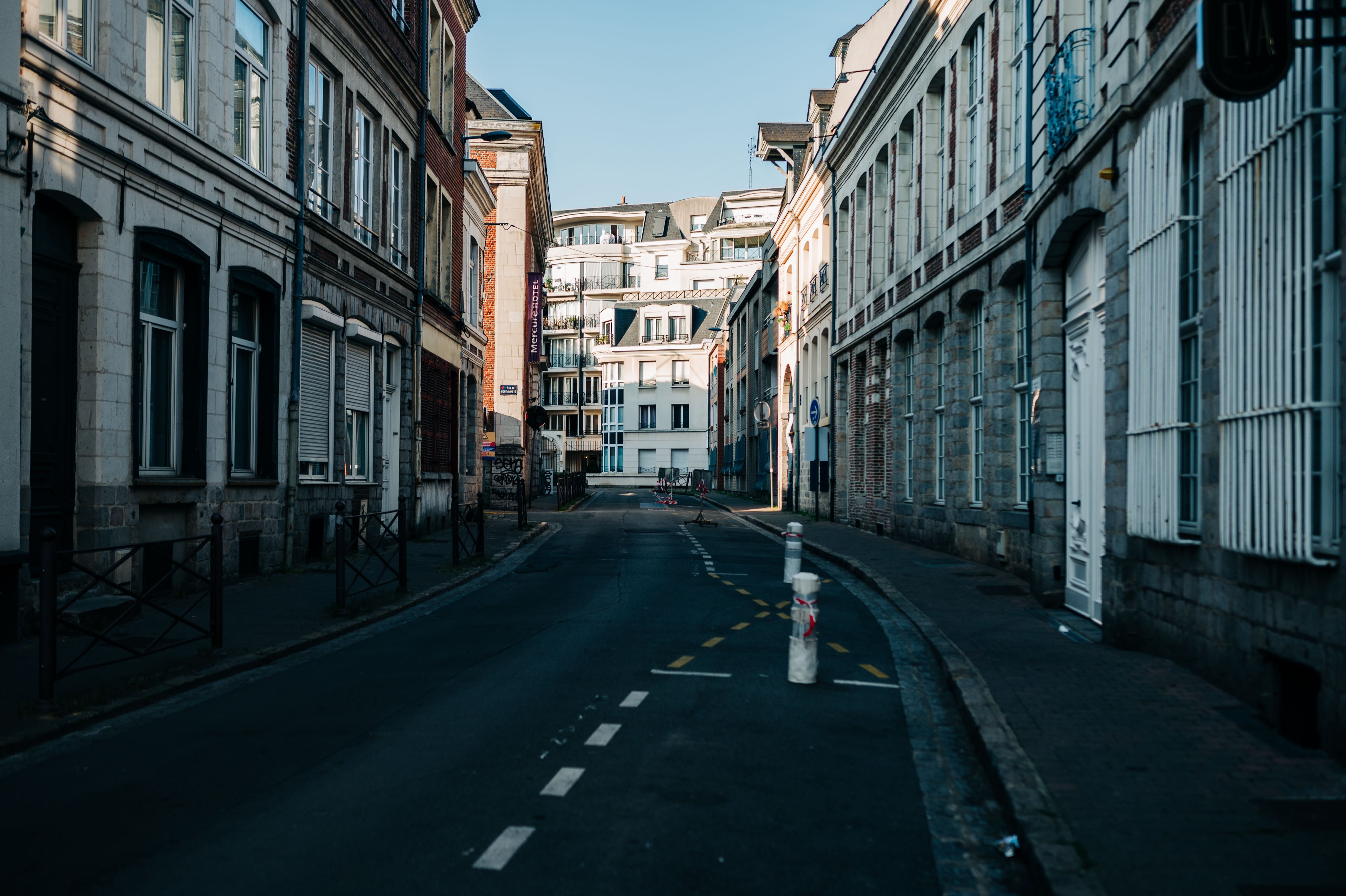 Symmetrical View of a Street between Buildings in City · Free Stock Photo