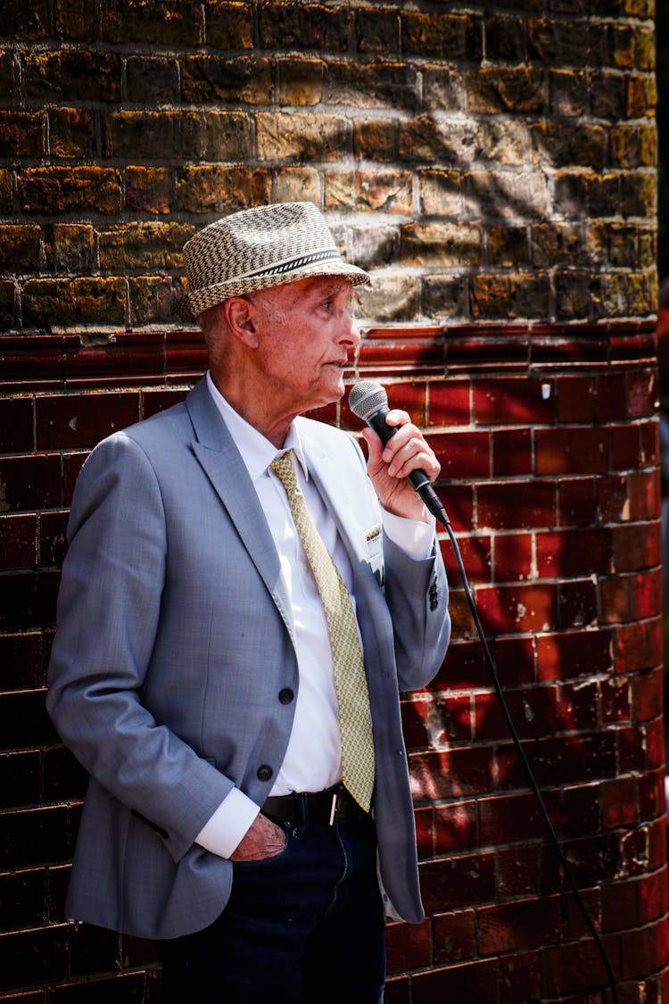 Old Elegant Man Singing On A Street 