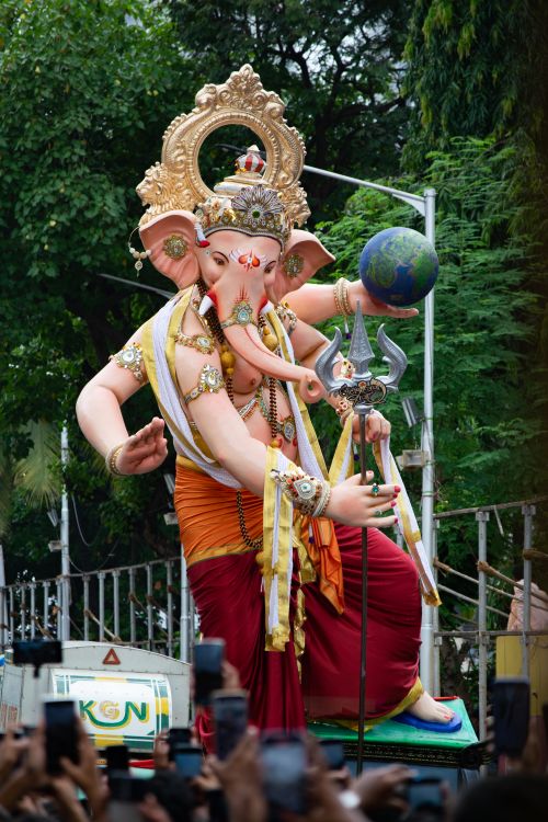 Free Colorful street celebration of Ganesh Chaturthi in Mumbai with a grand Ganesha idol. Stock Photo