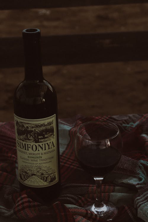 A Bottle and a Glass of Red Wine 