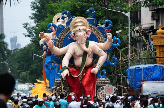 Vibrant Ganesh Chaturthi procession in Mumbai showcasing a large Lord Ganesha statue.