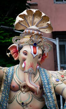 Colorful idol of Lord Ganesha at a festival parade in Mumbai, Maharashtra, India.