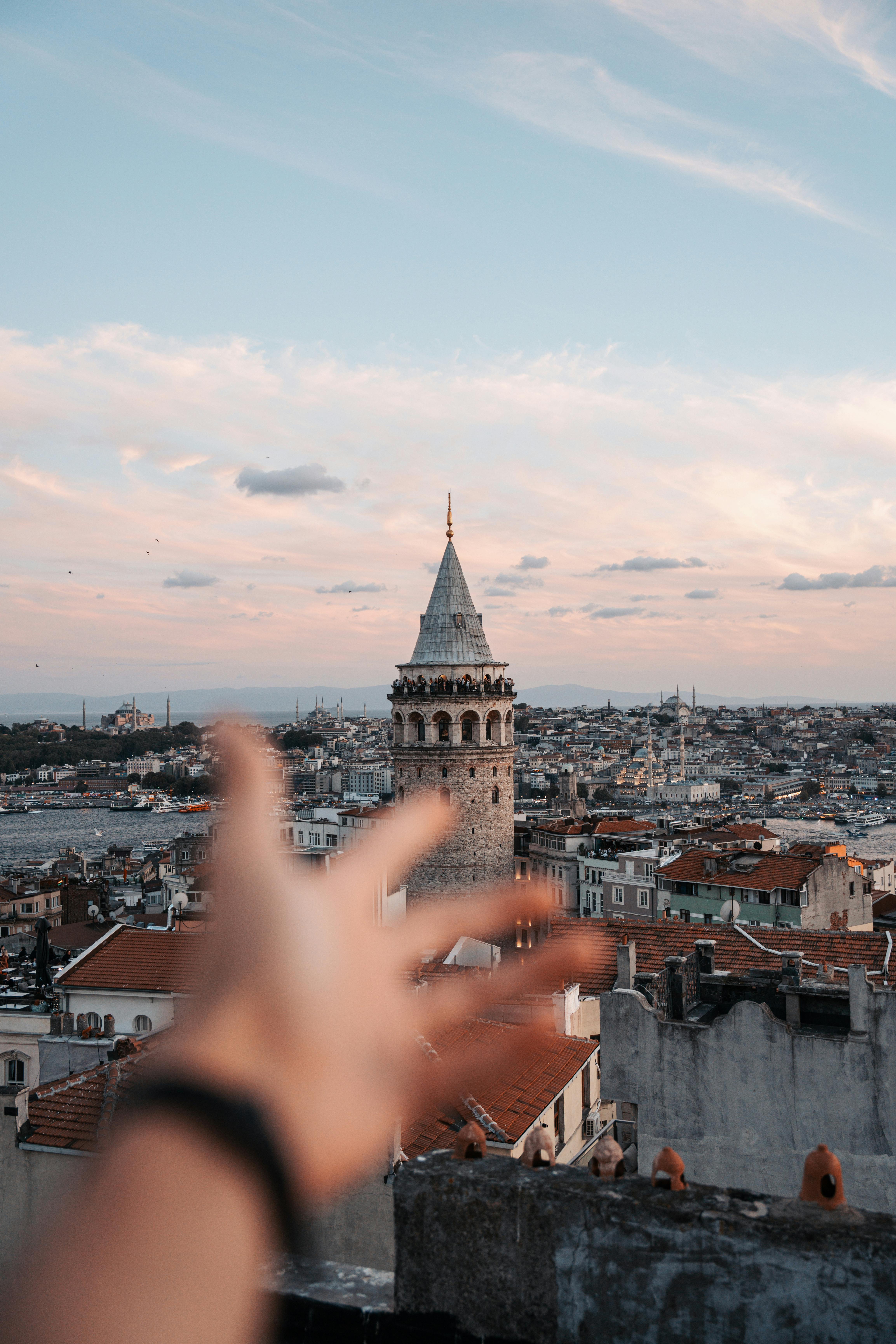 a person s hand reaching out to the sky with a city in the background